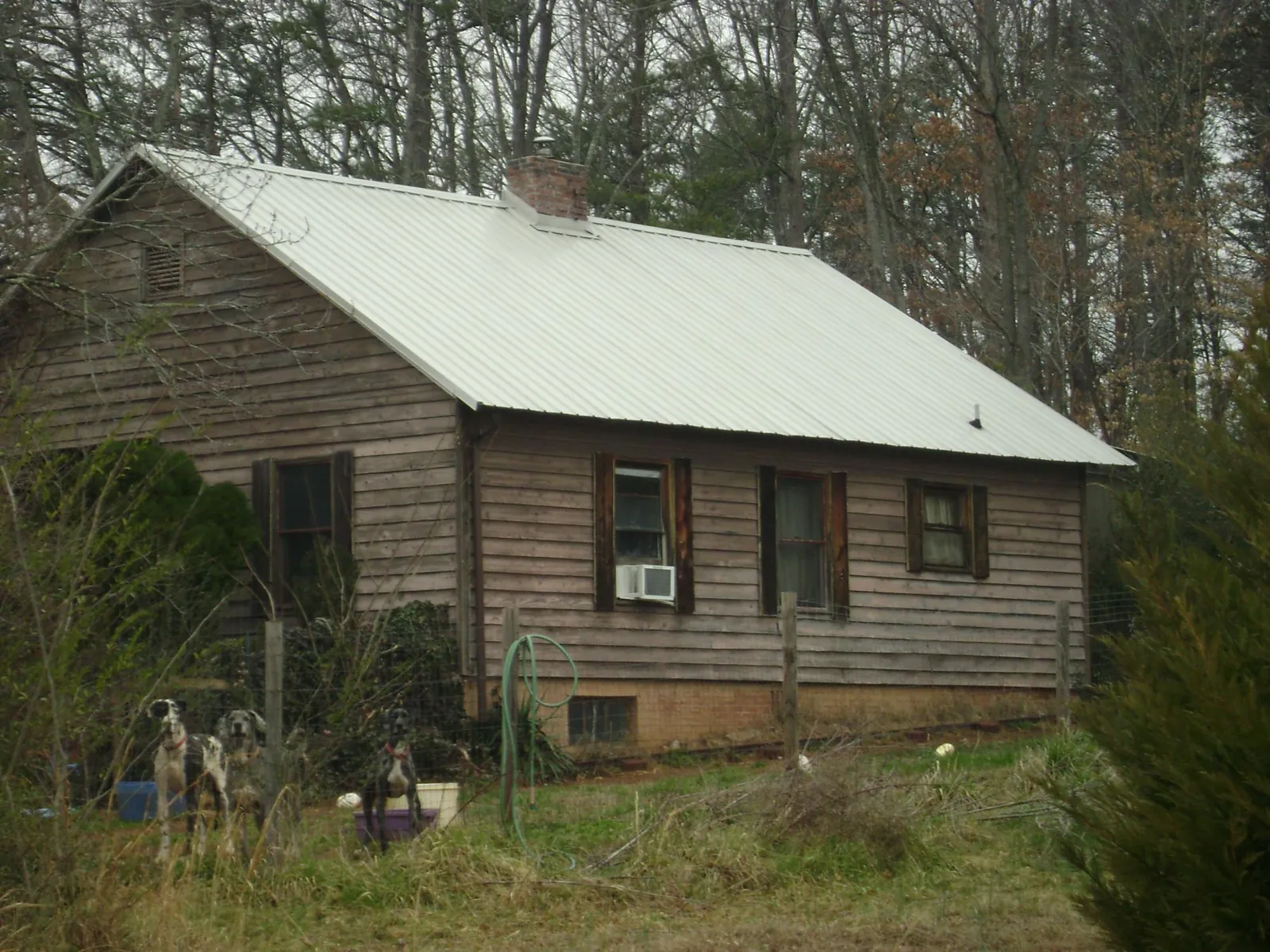 White metal roof on an old wood sided farmhouse, from a Metal Roof Installation job in Remsen